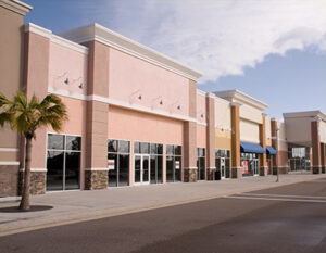mpty strip mall with pastel stucco and stone accents